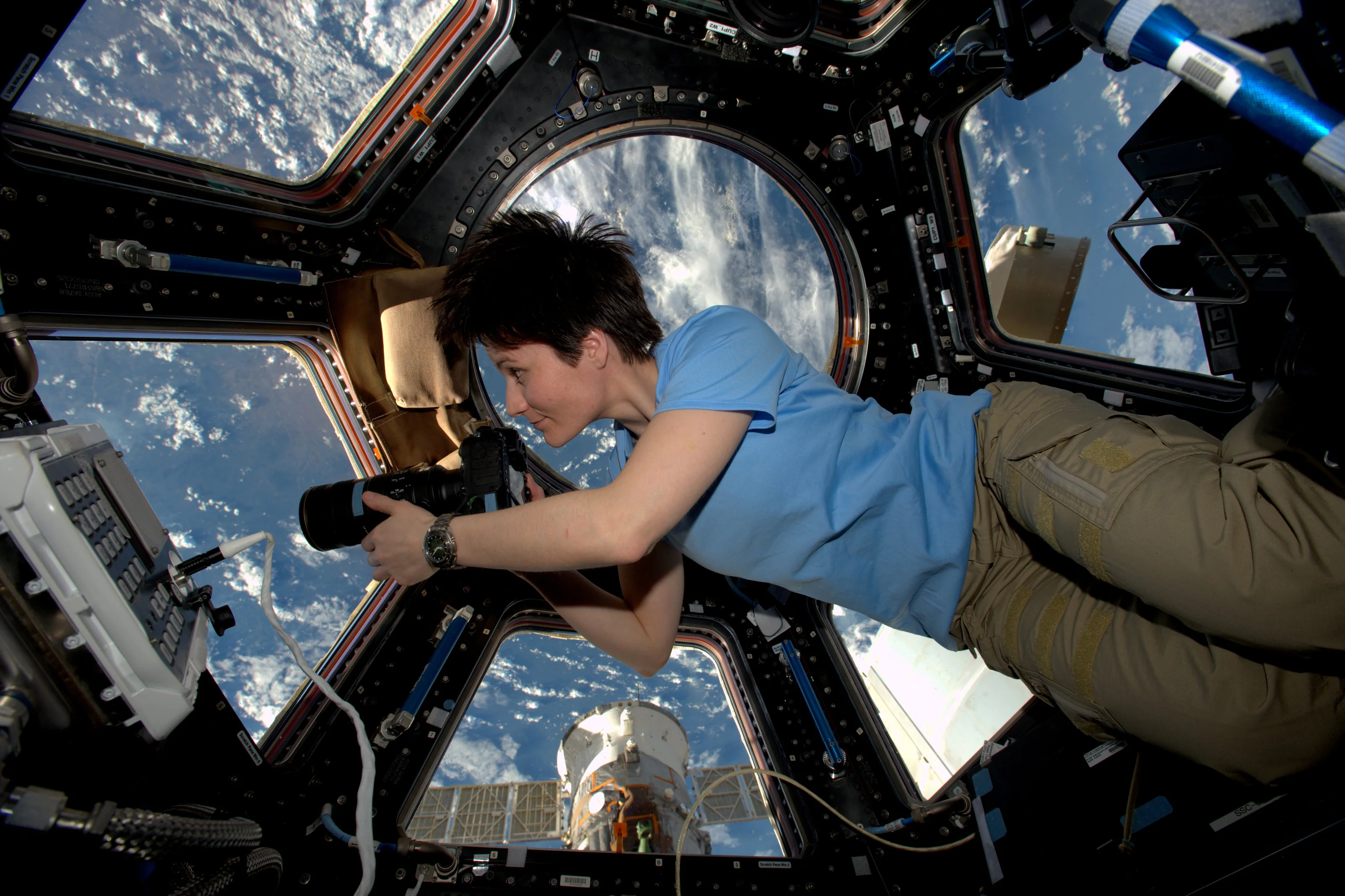 Astronaut Samantha Cristoforetti photographing Earth from
            the ISS Cupola